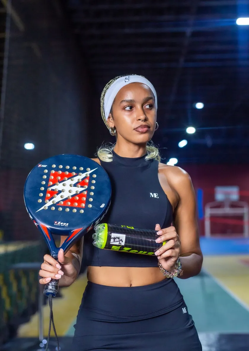 Padel player on an indoor court in London